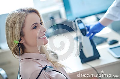 Middle-aged female patient being tested for auditory acuit Stock Photo