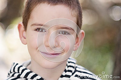 A small boy with a tawny glint in his brown eyes Stock Photo