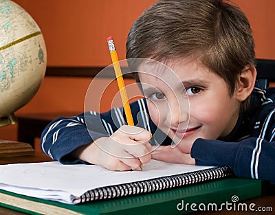 Smiling boy doing homework Stock Photo