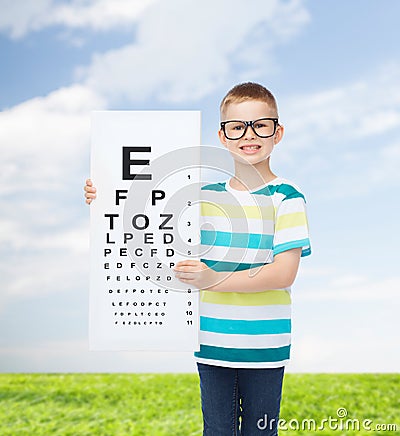 Smiling boy in eyeglasses with white blank board Stock Photo