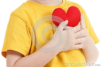 Smiling boy holding a red heart figurine. symbol of love, family, . Concept of the family and children. Stock Photo