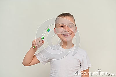 a smiling boy holds a toothbrush in his hand. mock up Stock Photo