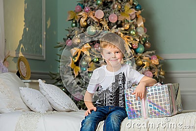 Smiling boy hugging the box close . Christmas Stock Photo