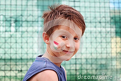 Smiling boy with hungarian tricolor trikolor his face Stock Photo