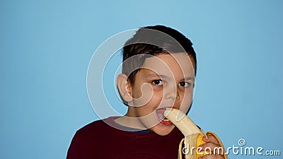 The boy eats a banana Stock Photo