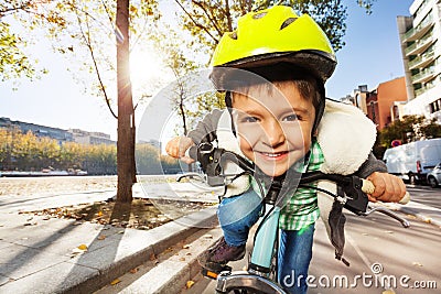 Smiling boy in safety helmet riding his bike Stock Photo