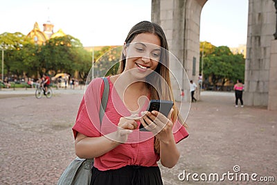 Smiling Brazilian girl using smartphone in Porto Alegre, Rio Grande do Sul, Brazil Stock Photo