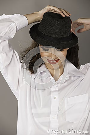 Smiling brunette woman with hat and red lips Stock Photo