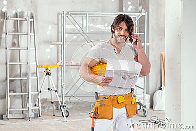 Smiling builder or architect holding a blueprint Stock Photo