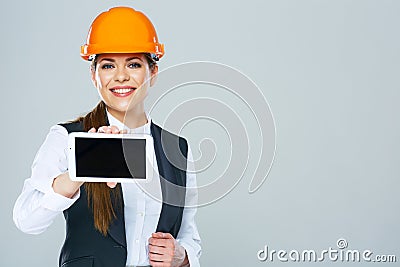 Smiling builder business woman showing tablet PC with yours inf Stock Photo