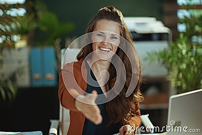 smiling business owner woman stretching hand for handshake Stock Photo