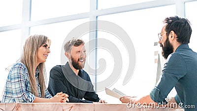 Smiling business partners reaching out to each other for a handshake Stock Photo