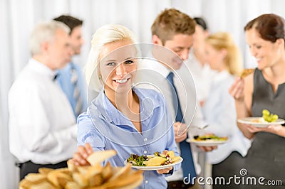 Smiling business woman during company lunch buffet Stock Photo