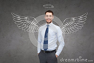 Smiling businessman with angel wings and nimbus Stock Photo