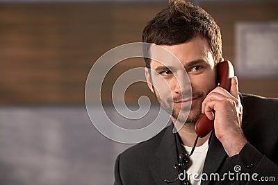 Smiling businessman on call Stock Photo