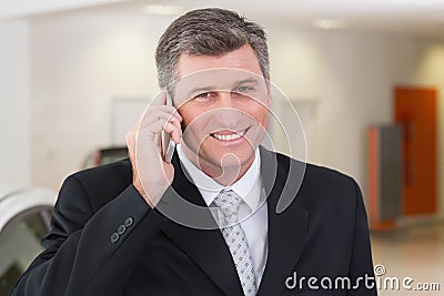 Smiling businessman calling with his mobile phone Stock Photo