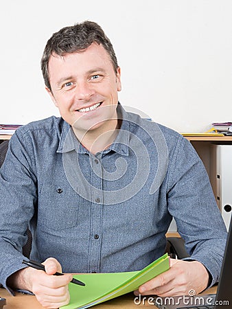 Smiling businessman casual sit at office table desk Stock Photo