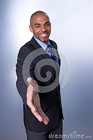 Smiling businessman giving hand Stock Photo