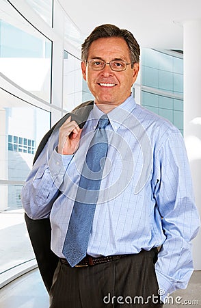 Smiling Businessman Leaving The Office Stock Photo