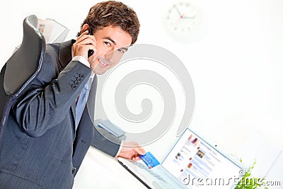 Smiling businessman making purchase by phone Stock Photo