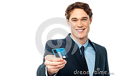 Smiling businessman offering his debit card to you Stock Photo