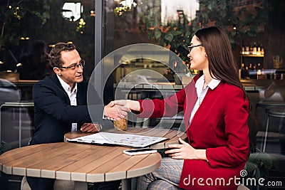 Smiling businessman shaking hands with his business partner Stock Photo