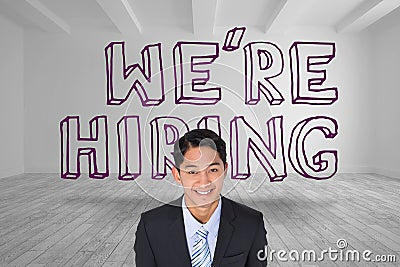 Smiling businessman standing in front of were hiring graphic Stock Photo