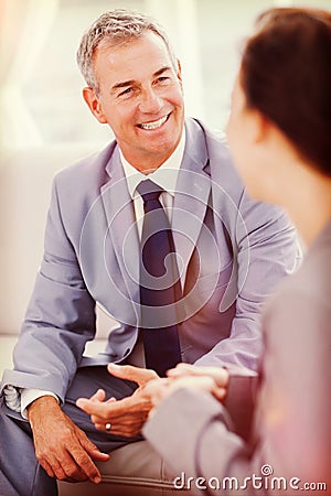 Smiling businessman talking to his workmate Stock Photo