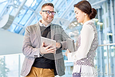 Smiling Businessman Talking to Young Woman Stock Photo