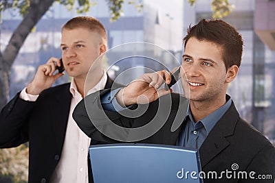 Smiling businessmen making phone call Stock Photo