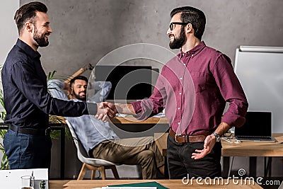 smiling businessmen shaking hands Stock Photo