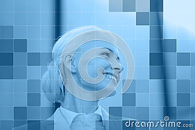 Smiling businesswoman behind monochrome blue grid Stock Photo