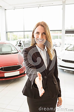 Smiling businesswoman reaching her hand Stock Photo