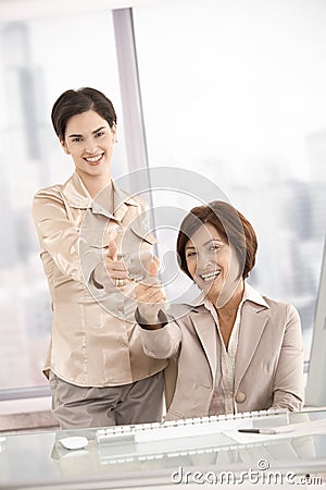 Smiling businesswomen giving thumb up Stock Photo