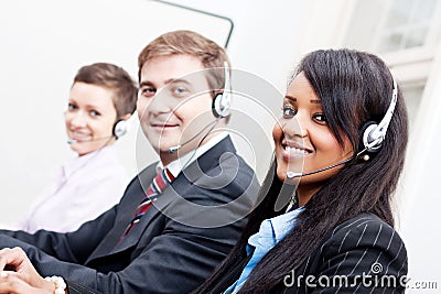 Smiling callcenter agent with headset support Stock Photo