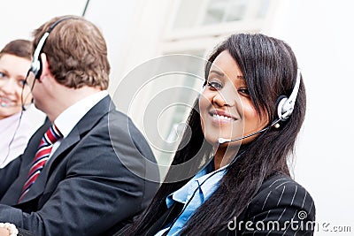 Smiling callcenter agent with headset support Stock Photo