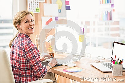 Smiling casual designer working with digitizer Stock Photo