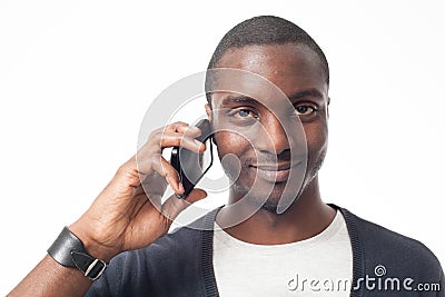 Smiling casual dressed black man at the phone. Stock Photo