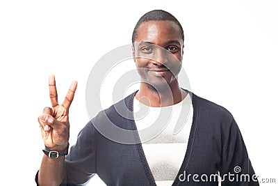 Smiling casual dressed black man showing peace sign. Stock Photo
