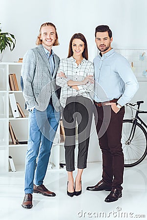 smiling caucasian businesspeople standing in office and looking Stock Photo