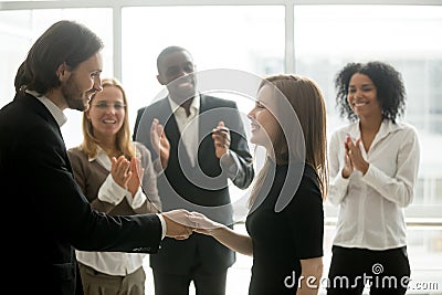 Smiling ceo handshaking successful female worker showing respect Stock Photo