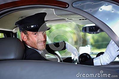 Smiling chauffeur in limousine Stock Photo