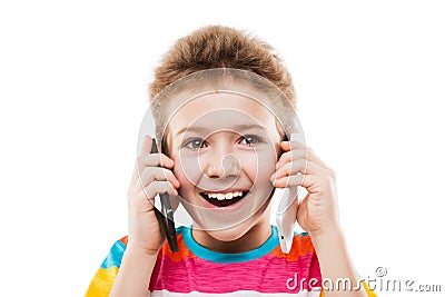 Smiling child boy talking two mobile phones or smartphones Stock Photo