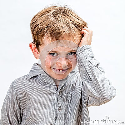 Smiling child expressing shyness with his body language, isolated portrait Stock Photo