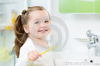 Smiling child girl brushing teeth Stock Photo