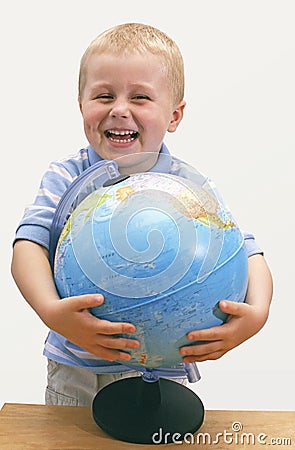 Smiling child with globe Stock Photo