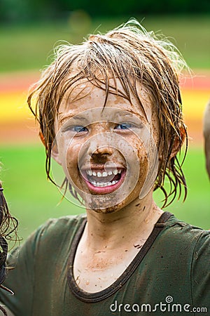 Smiling child with muddy face Stock Photo