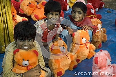 Smiling children- Doll sellers family Editorial Stock Photo