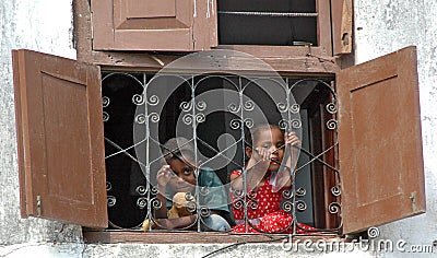 Smiling children in window Editorial Stock Photo