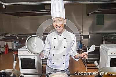 Smiling Chinese cook in kitchen Stock Photo